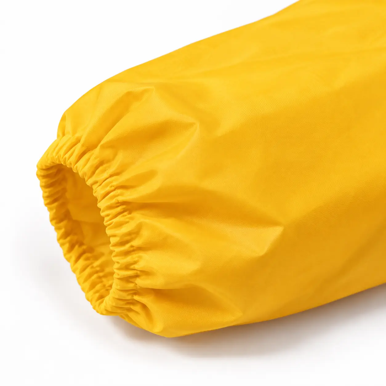 Editorial close-up of a yellow protective sleeve and gathered cuff